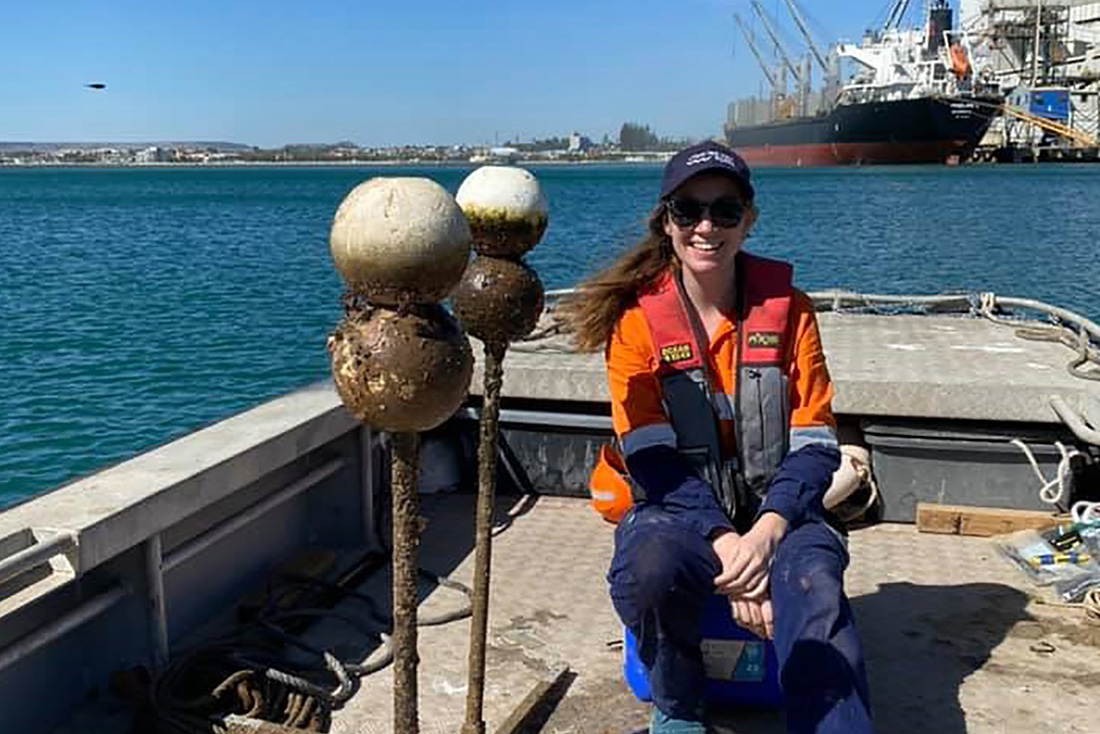 Staff member on small vessel with dirty floats