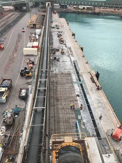 Wharf 4 under construction with steel rods and beams over concrete.