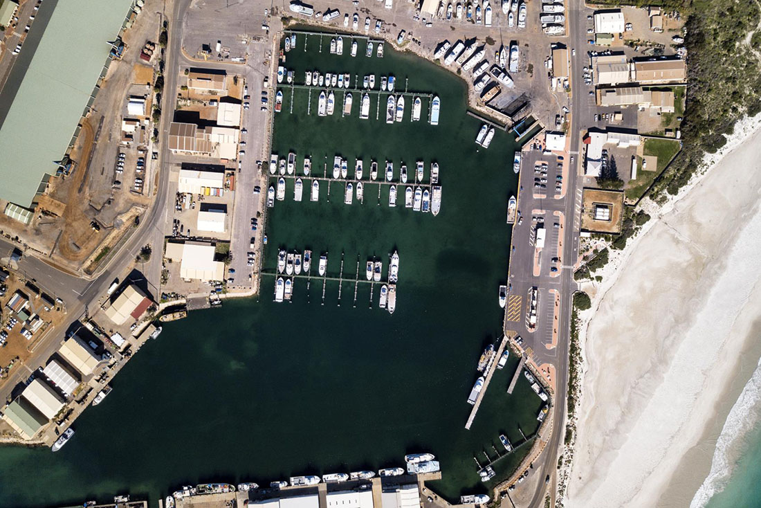 Aerial view of Fishing Boat Harbour surrounded by roads and sheds.