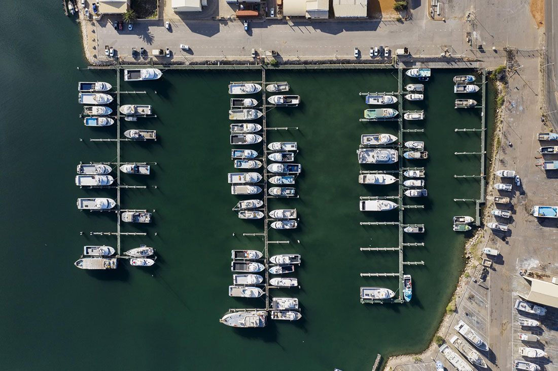 Overhead view of pens at Fishing Boat Harbour. Most are filled.