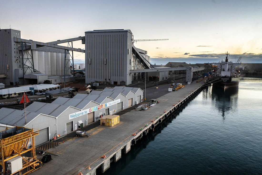 View of berth, sheds, ship and welcome to Geraldton sign
