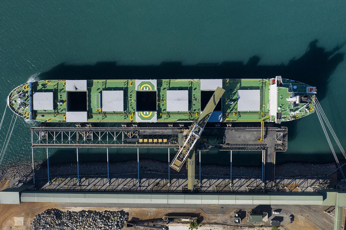 Overhead view of cargo ship being loaded.