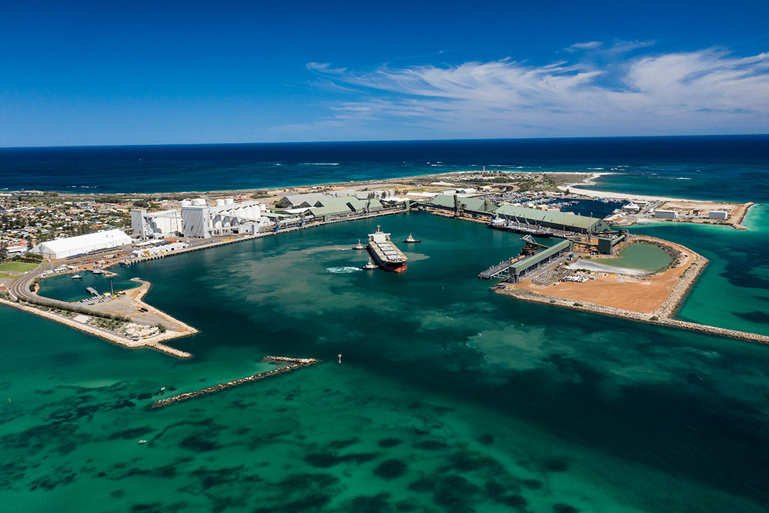 Aerial view of Geraldton Port with 3 tugs guding a cargo ship