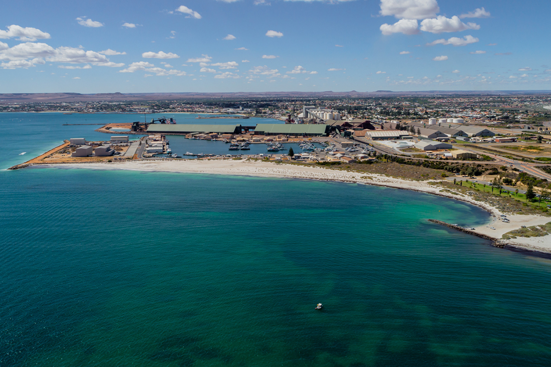 Aerial view of Pages Beach looking North-East towards the fishing boat harbour and the Moresby Ranges