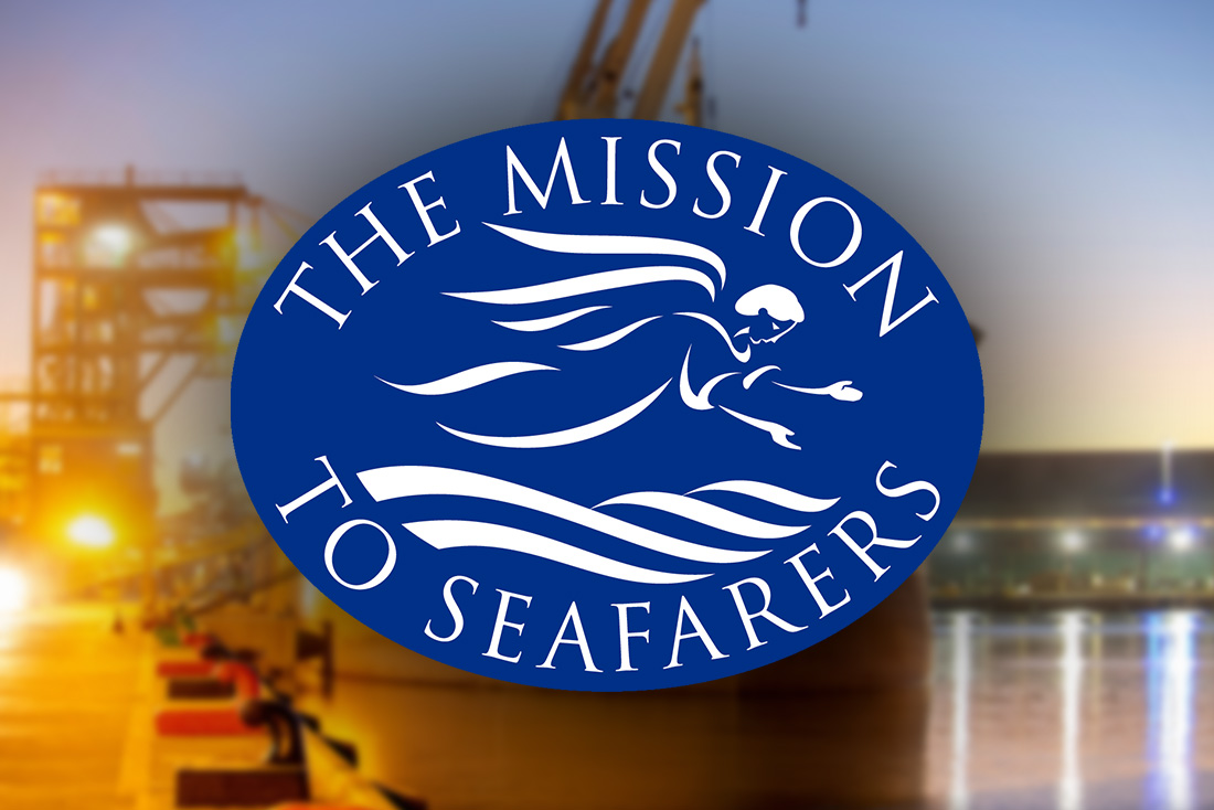 Logo for the Mission to Seafarers in front of blurred image of Geraldton Port at night